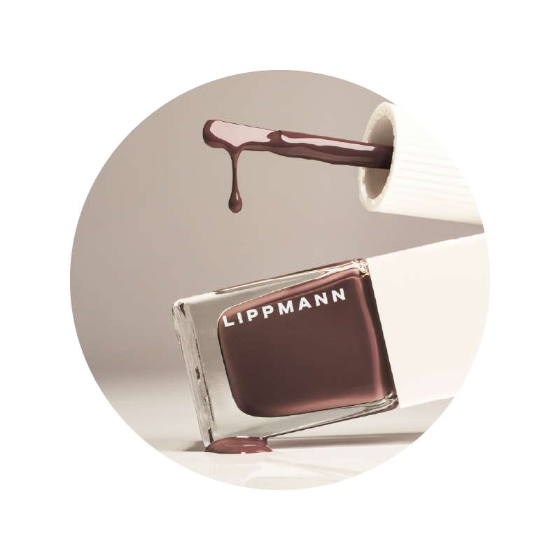 brown deborah lippmann bottle tiltled bottle of deborah lippmann bottle brush above dripping down